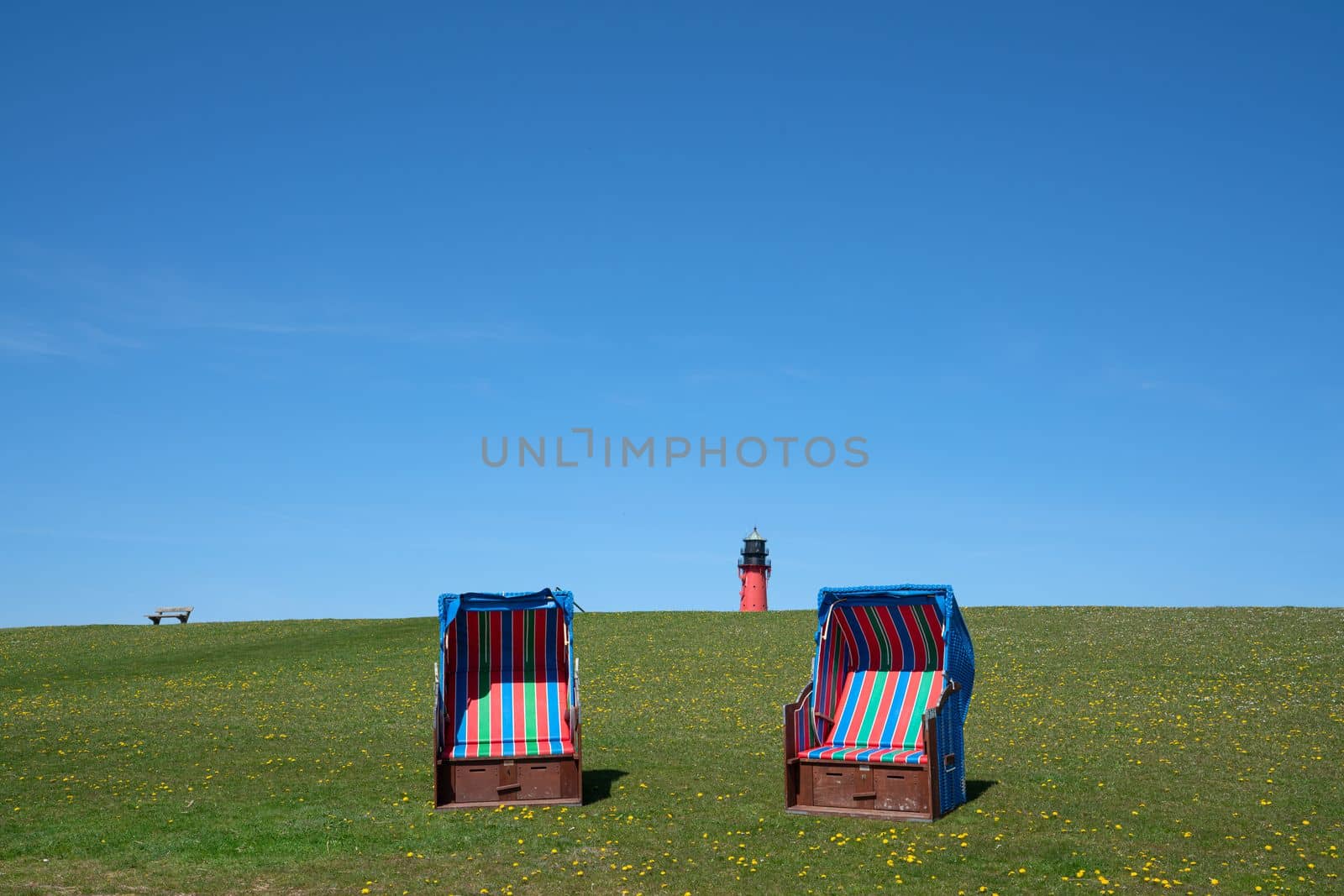 Panoramic image of the landscape along the dikes of Pellworm with beach chairs, North Frisia, Germany 