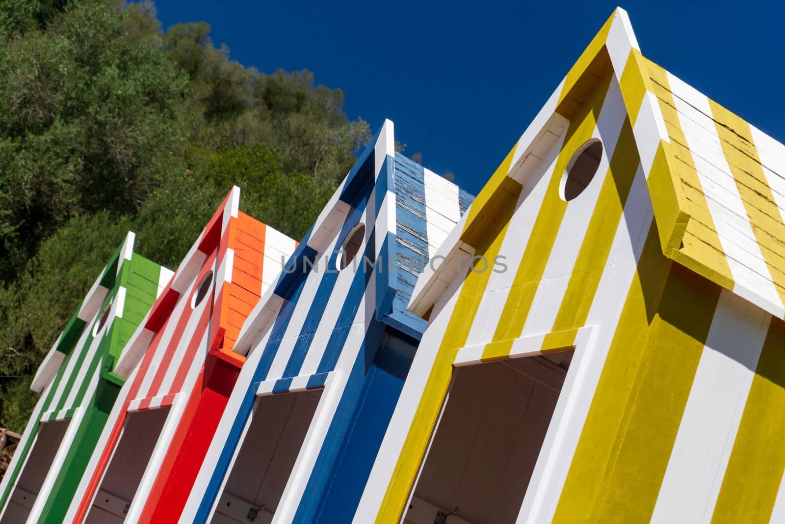 Colorful striped changing houses on the beach in Portugal