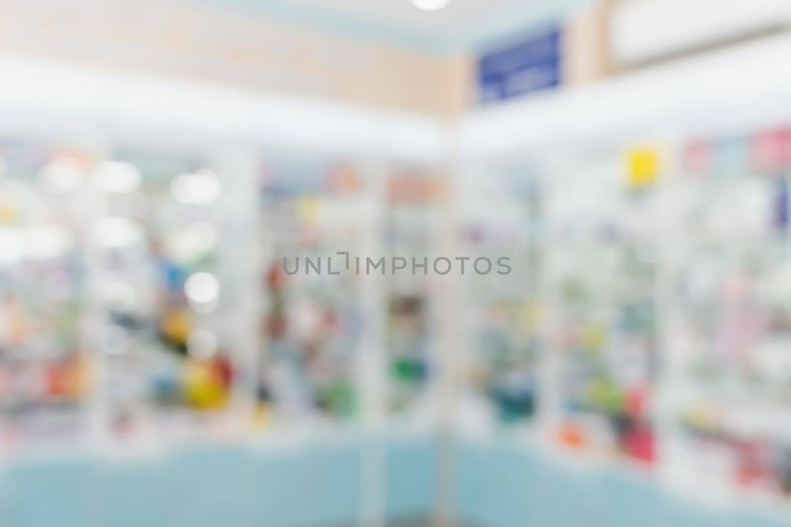Pharmacy blurred abstract background qualified drug, medicinal product on shelf background. Blurry light tone wallpaper of drugstore's interior medications displayed on shelves for healthcare concept.