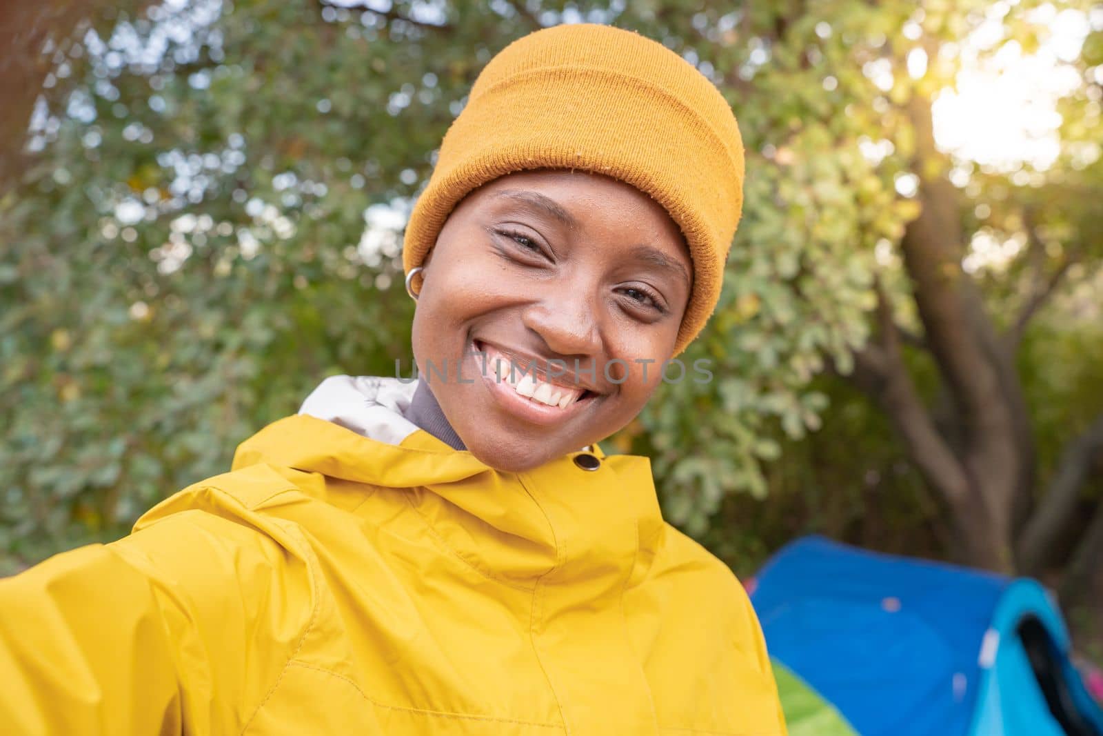 Selfie of african american woman smiling at nature - Pleased black girl in love with life. High quality photo