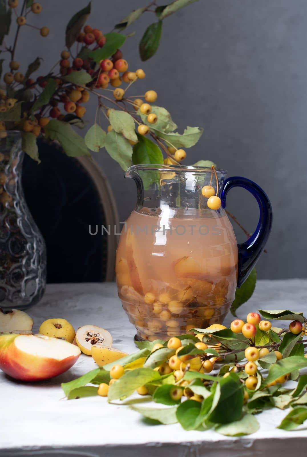 Assorted compote of apples and Japanese quince in a jug, delicious, vitamin drink, chaenomeles. High quality photo