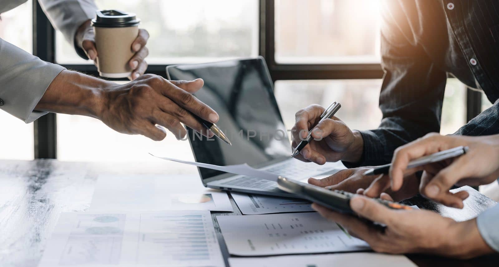 Business People Meeting using laptop computer,calculator,notebook,stock market chart paper for analysis Plans to improve quality next month. Conference Discussion Corporate Concept...