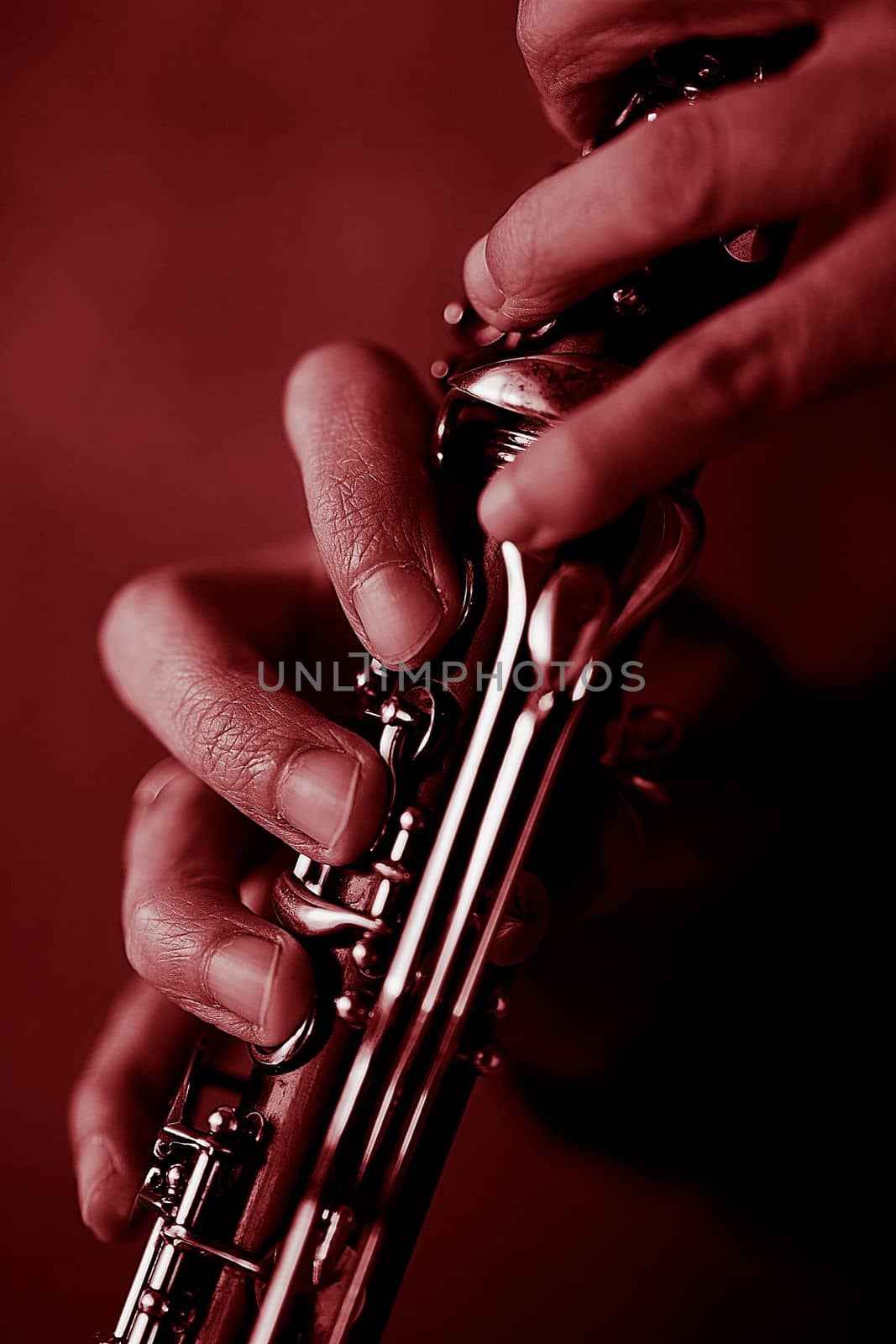 the hands of a musician on the clarinet - an ancient musical wooden instrument popular in classical brass marching jazz folk music, loved by children and adults, amateurs and professionals.. High quality photo