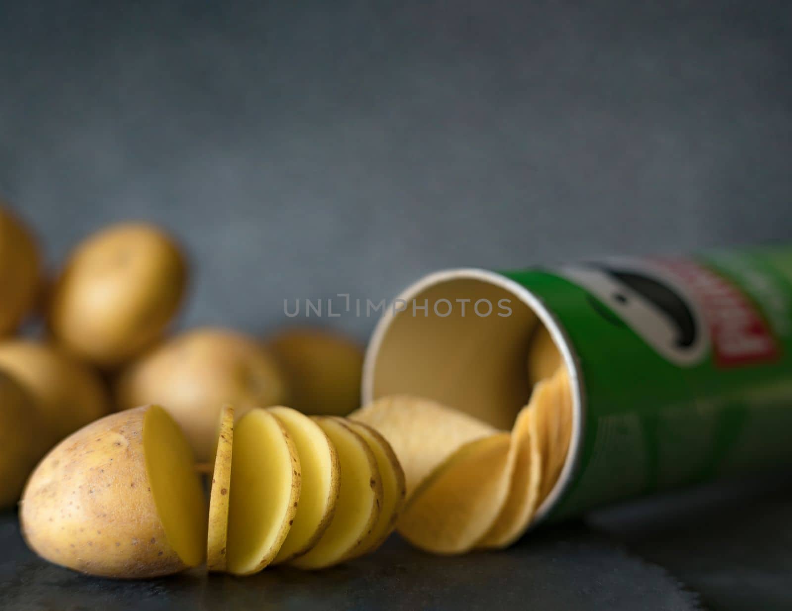 Potato slice into potato chips isolated on white background by Costin