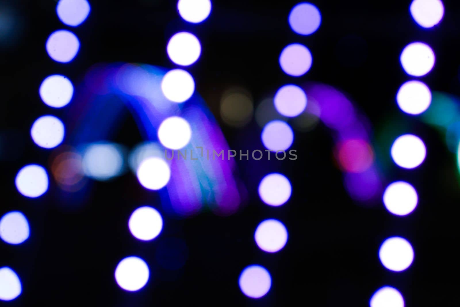 Hanging garlands against a backdrop of nighttime illuminations. by gelog67