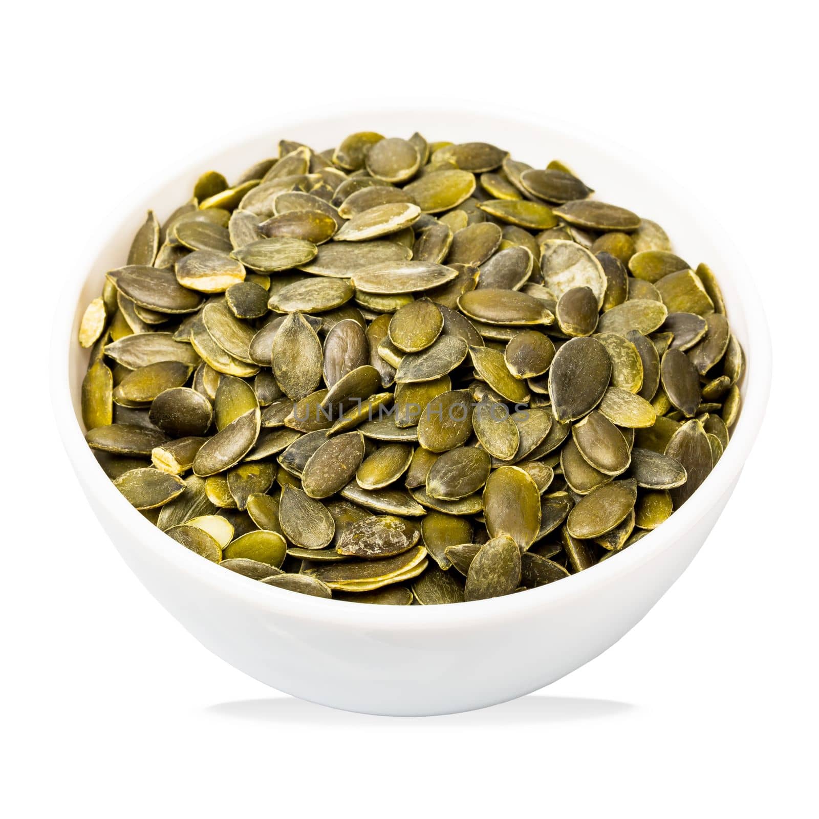 Bowl of pumpkin seeds isolated on white. Top view. Organic food