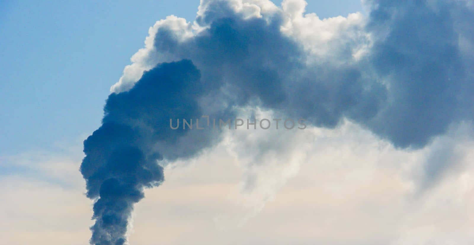 Clouds of thick smoke polluting the air against the sky. by gelog67