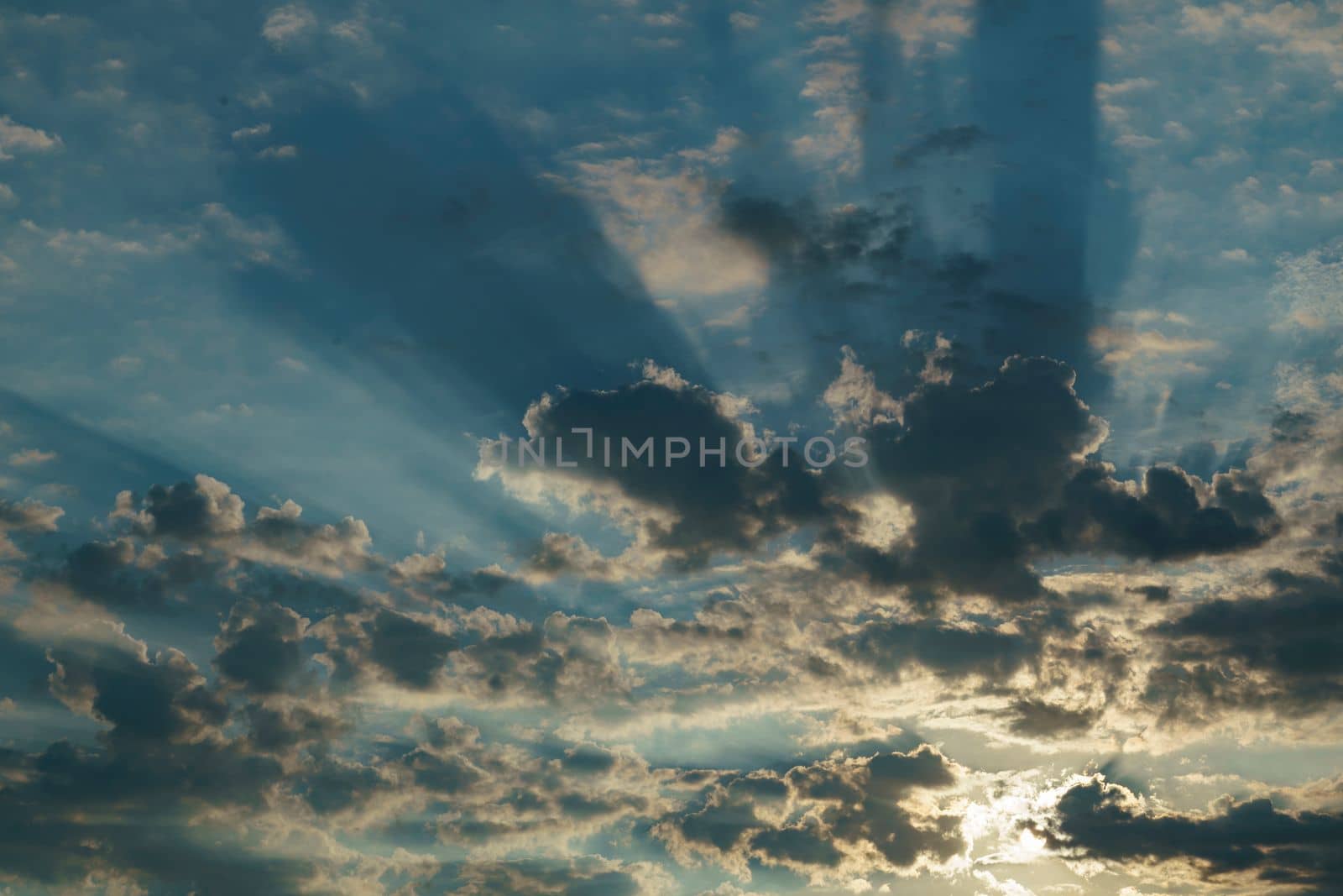 Stormy sky with dramatic clouds from an approaching thunderstorm at sunset Dramatic sky with cirrus and cumulus clouds under the blue sky before rain. Idyllic summer scene. Panoramic view. Recreation, ecotourism, nature in Italy by Costin
