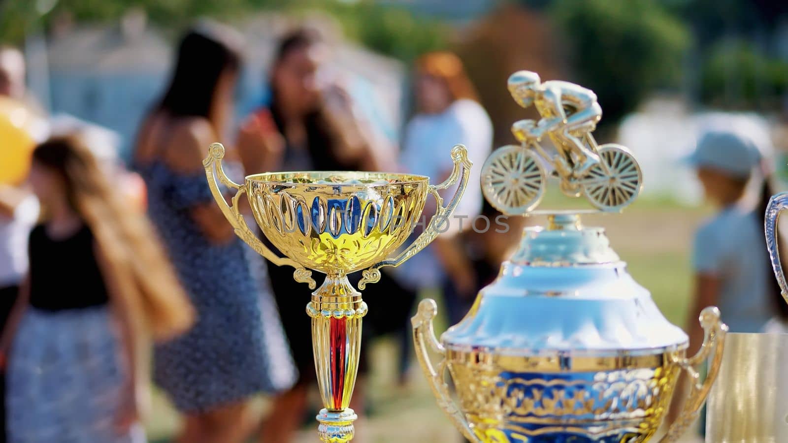 close-up, beautiful gold and silver cups, awards for outdoor cycling competition. High quality photo