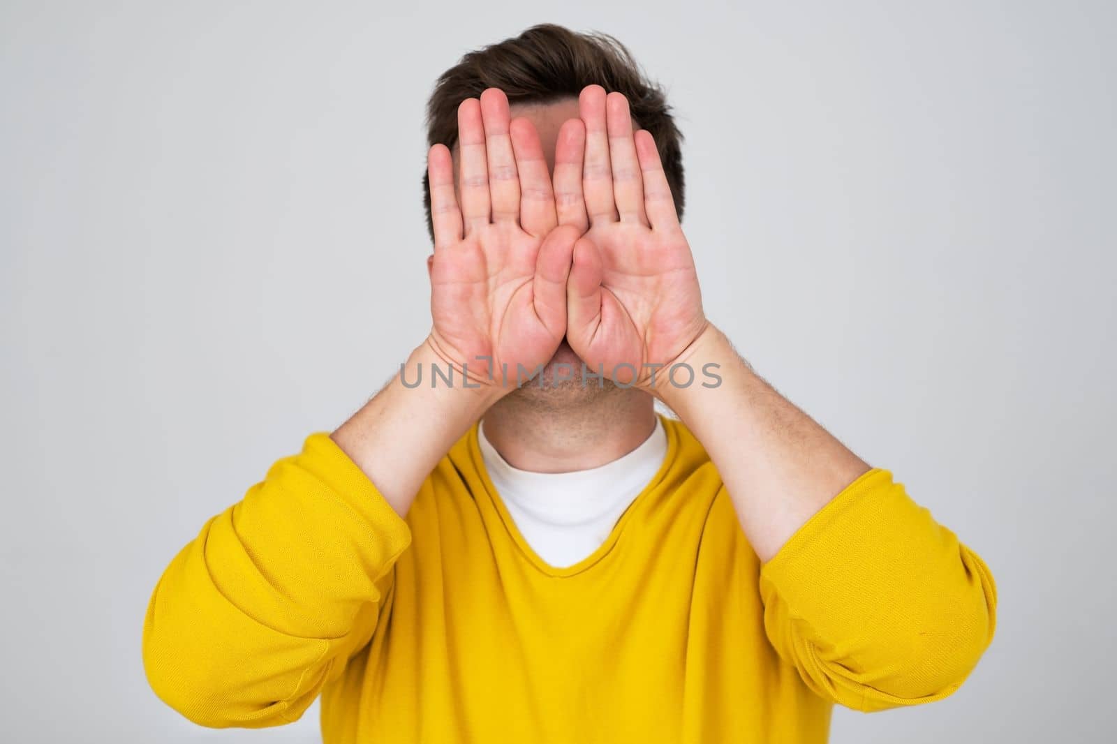 Anonymous caucasian man hiding his identity . Studio shot by koldunov