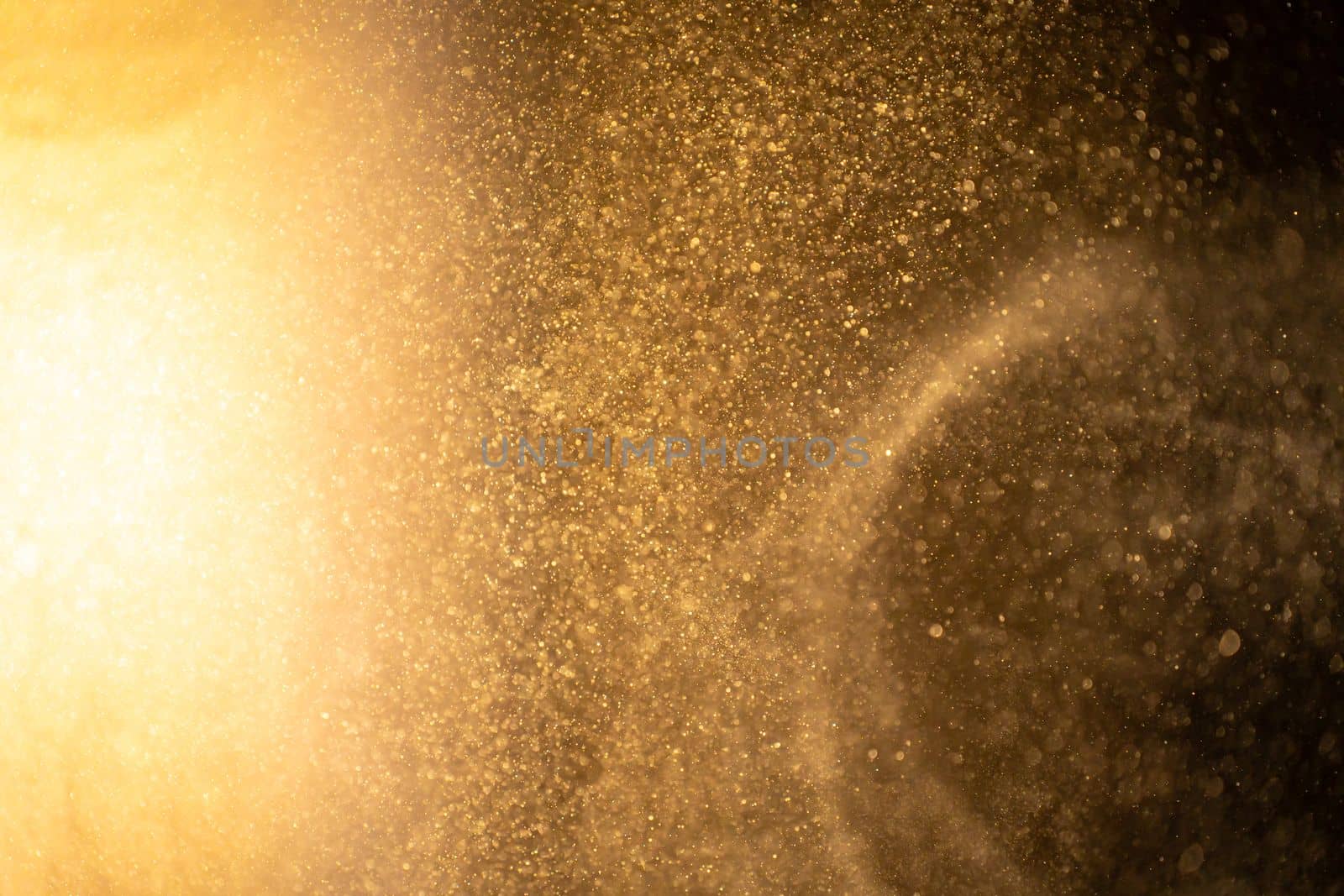 Gold dust particles abstract Bokeh star particle on Black Background. Futuristic glittering dots in space. High quality photo