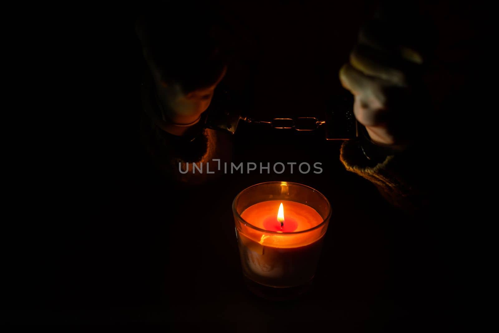 composition with the toy handcuffs, candle
