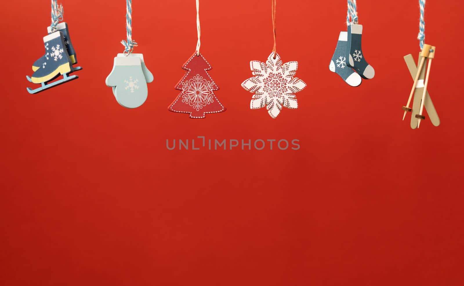 christmas decoration toys hanging over red background by Chechotkin