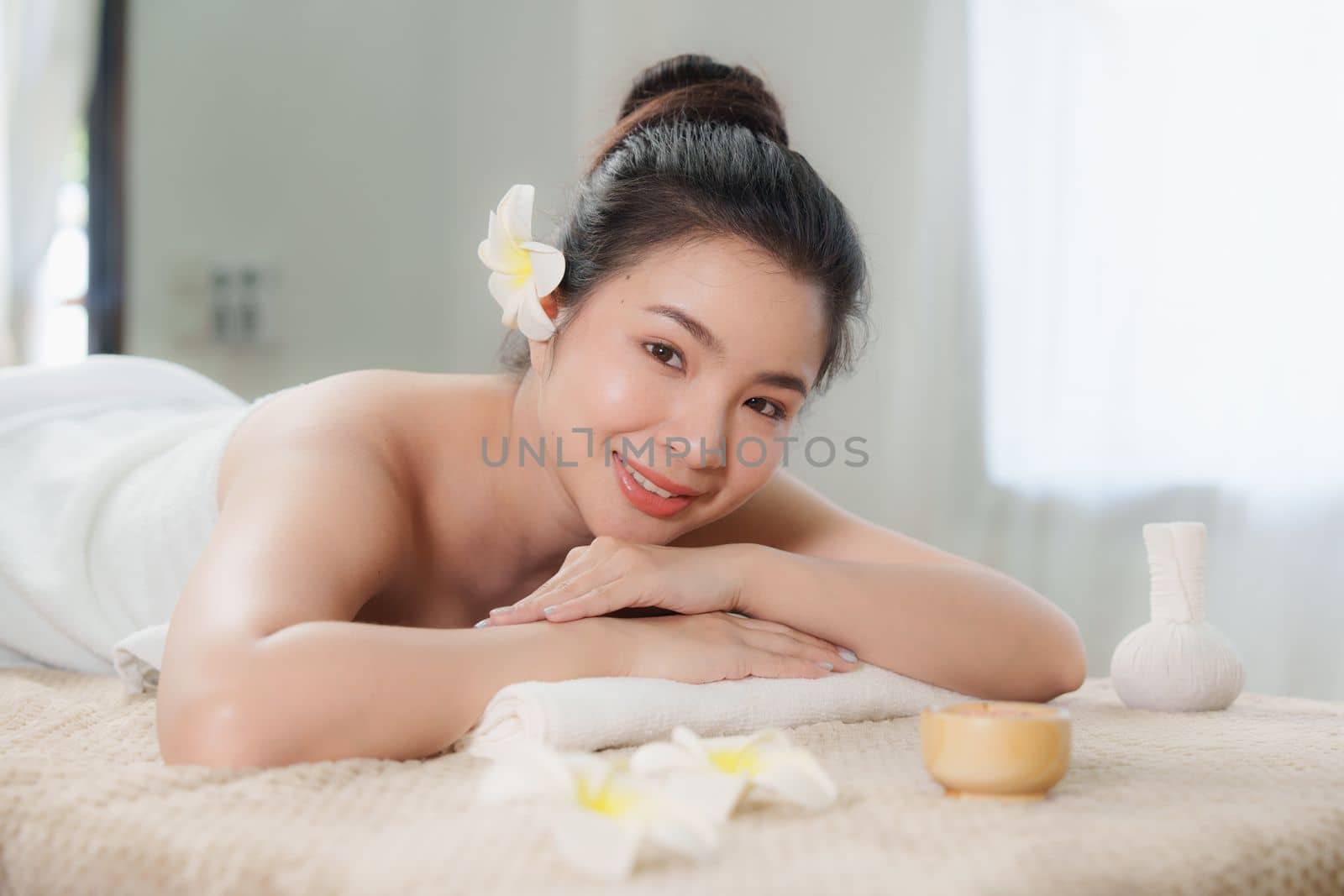 Young woman doing relaxing massage in spa salon. Female being massaged by a masseur. Spa and medicine concept.