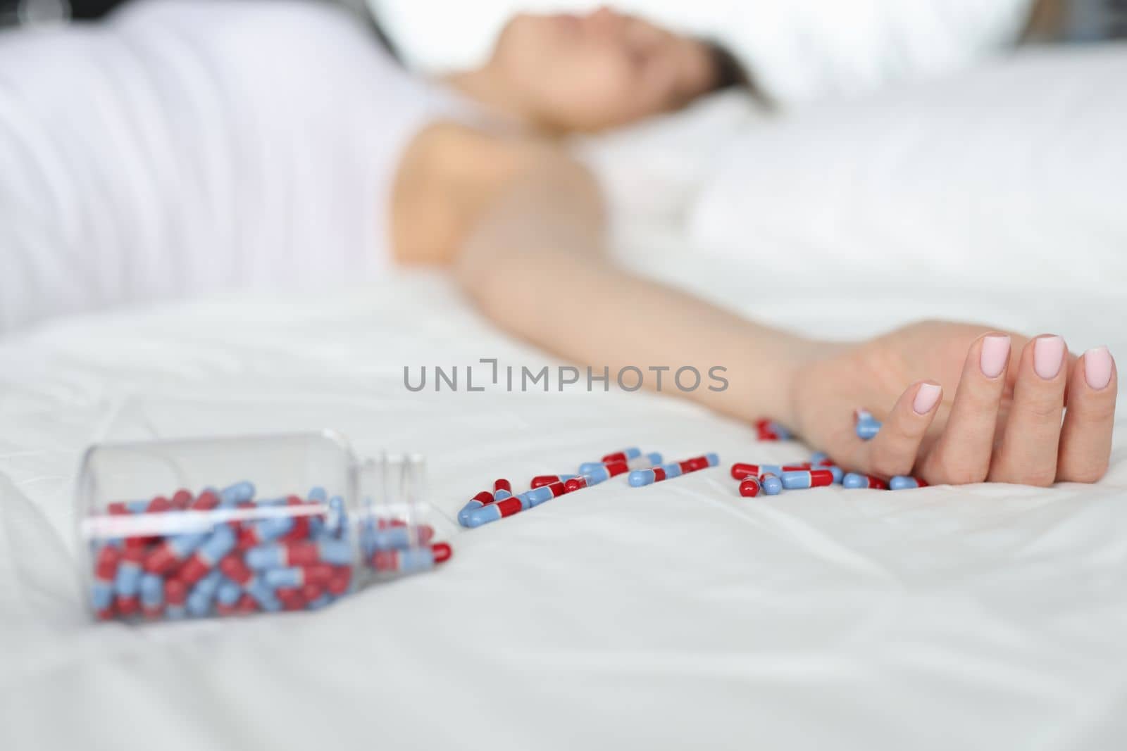 Overdose pills and drug addict background. Woman sleeps unconscious after eating pills on bed. Commits suicide and drug overdose concept