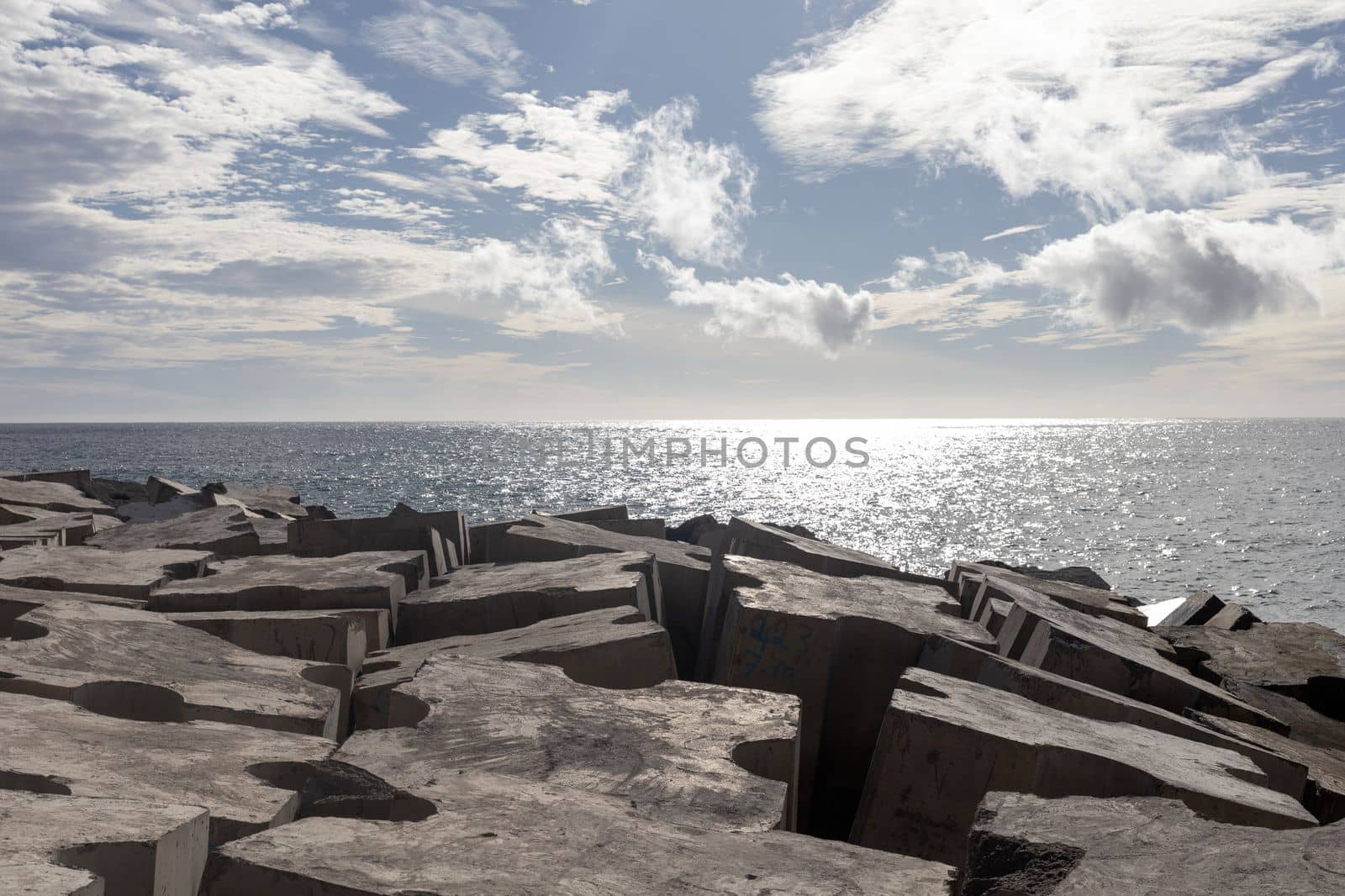 breakwater concrete blocks in the ocean sunny day by Chechotkin