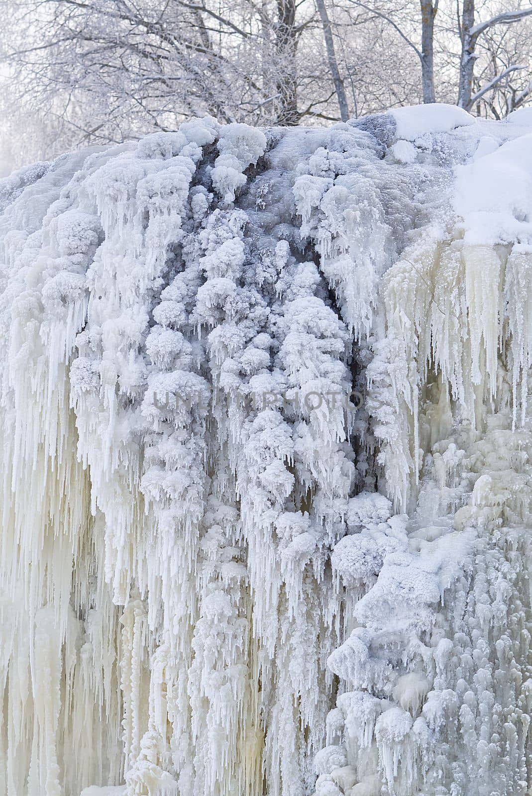 Frozen small mountain waterfall close up. Frozen Jagala Falls, Estonia. small river waterfall frozen in winter.