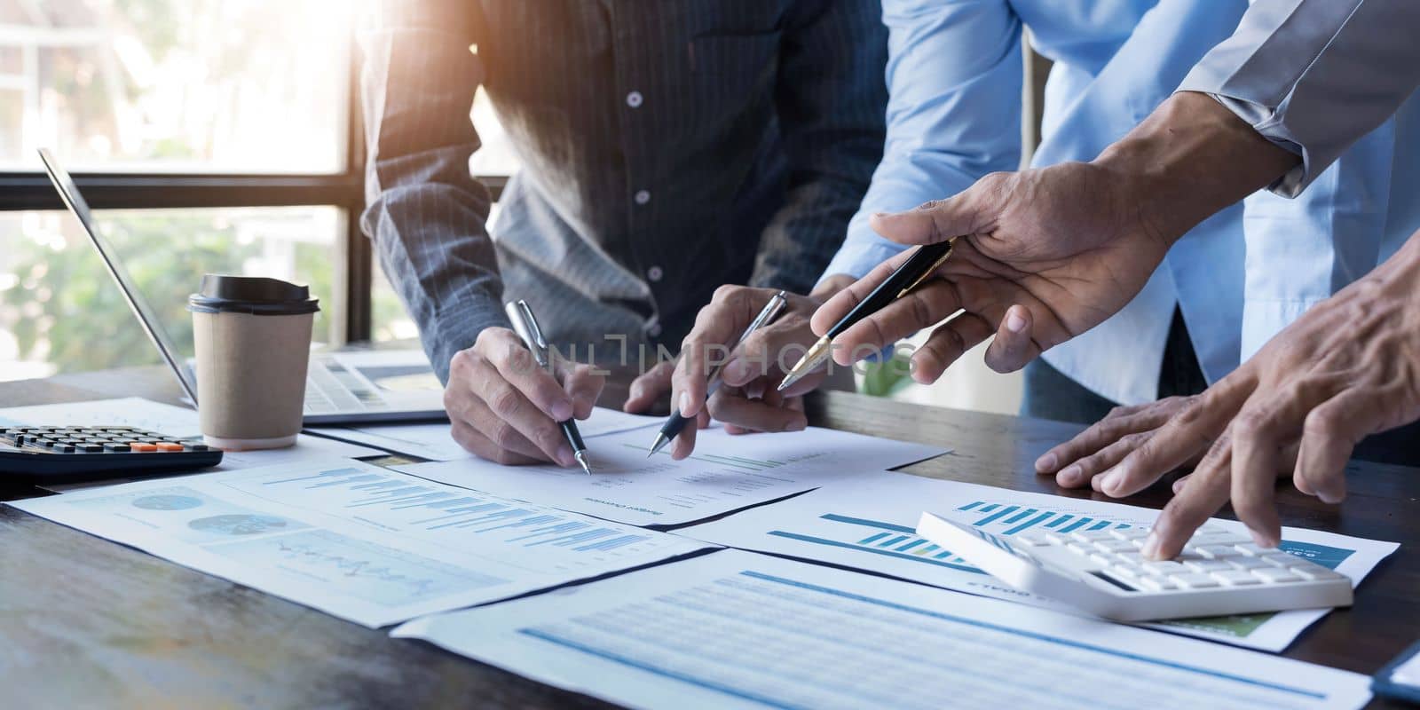 Business People Meeting using laptop computer,calculator,notebook,stock market chart paper for analysis Plans to improve quality next month. Conference Discussion Corporate Concept...