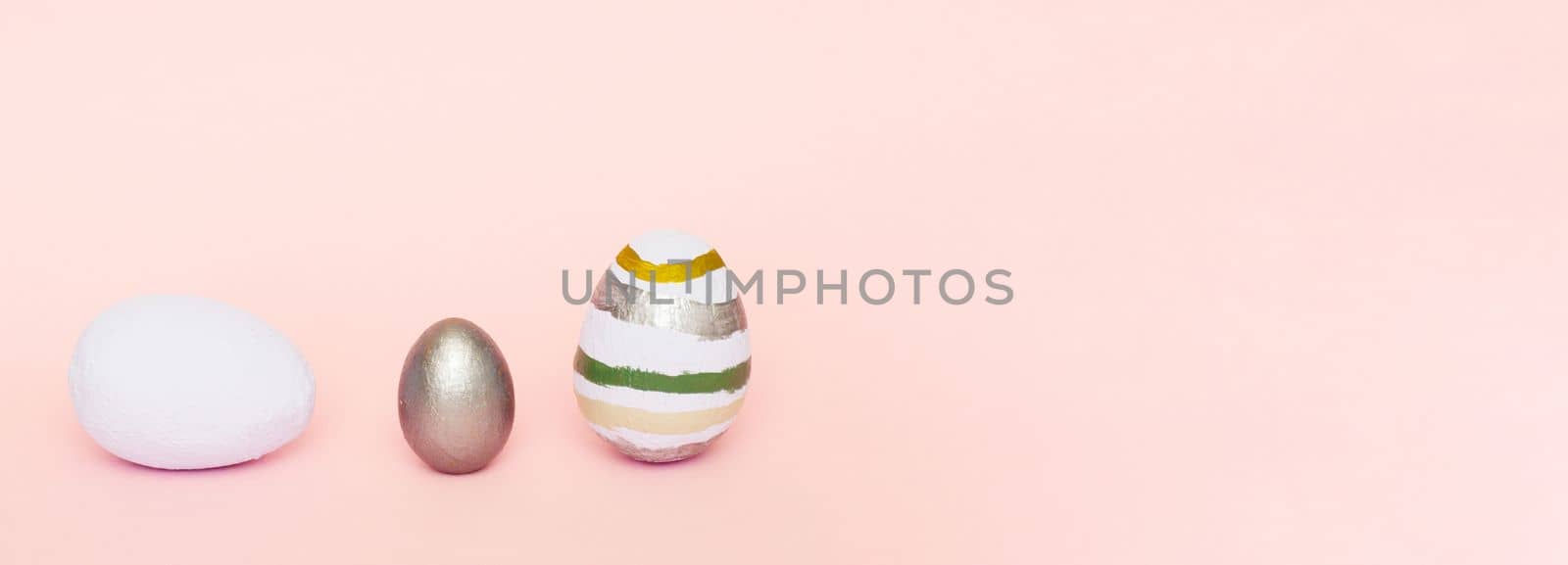 Easter composition of light blue, gray, pastel colors of decorative eggs on a pink pastel paper background. Easter concept..