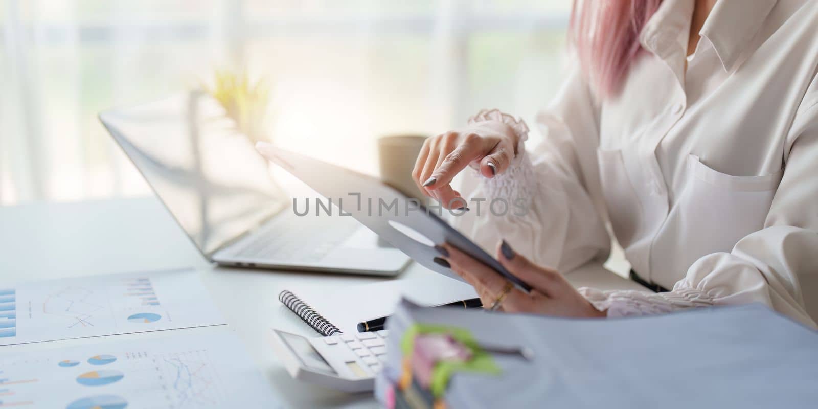 Asian Business woman working at home office and analyze financial report document. Accounting and Finance concept by itchaznong