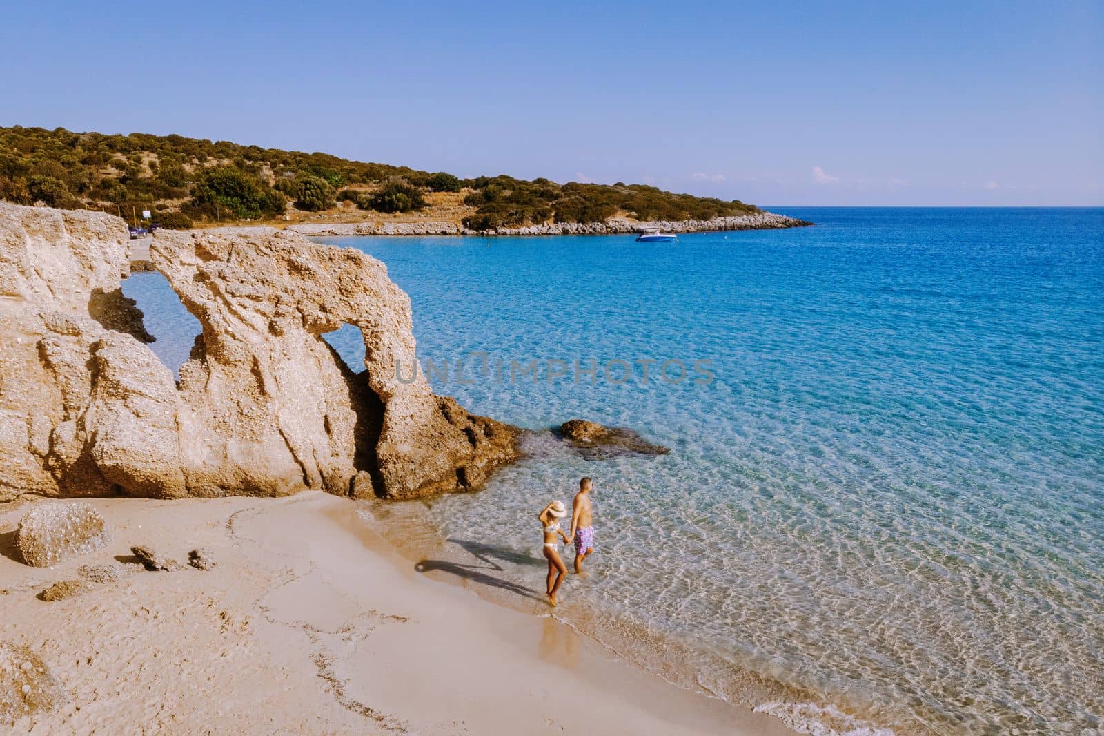 couple visit the Tropical beach of Voulisma beach, Istron, Crete, Greece during vacation,Most beautiful beaches of Crete island -Istron bay near Agios Nikolaos 