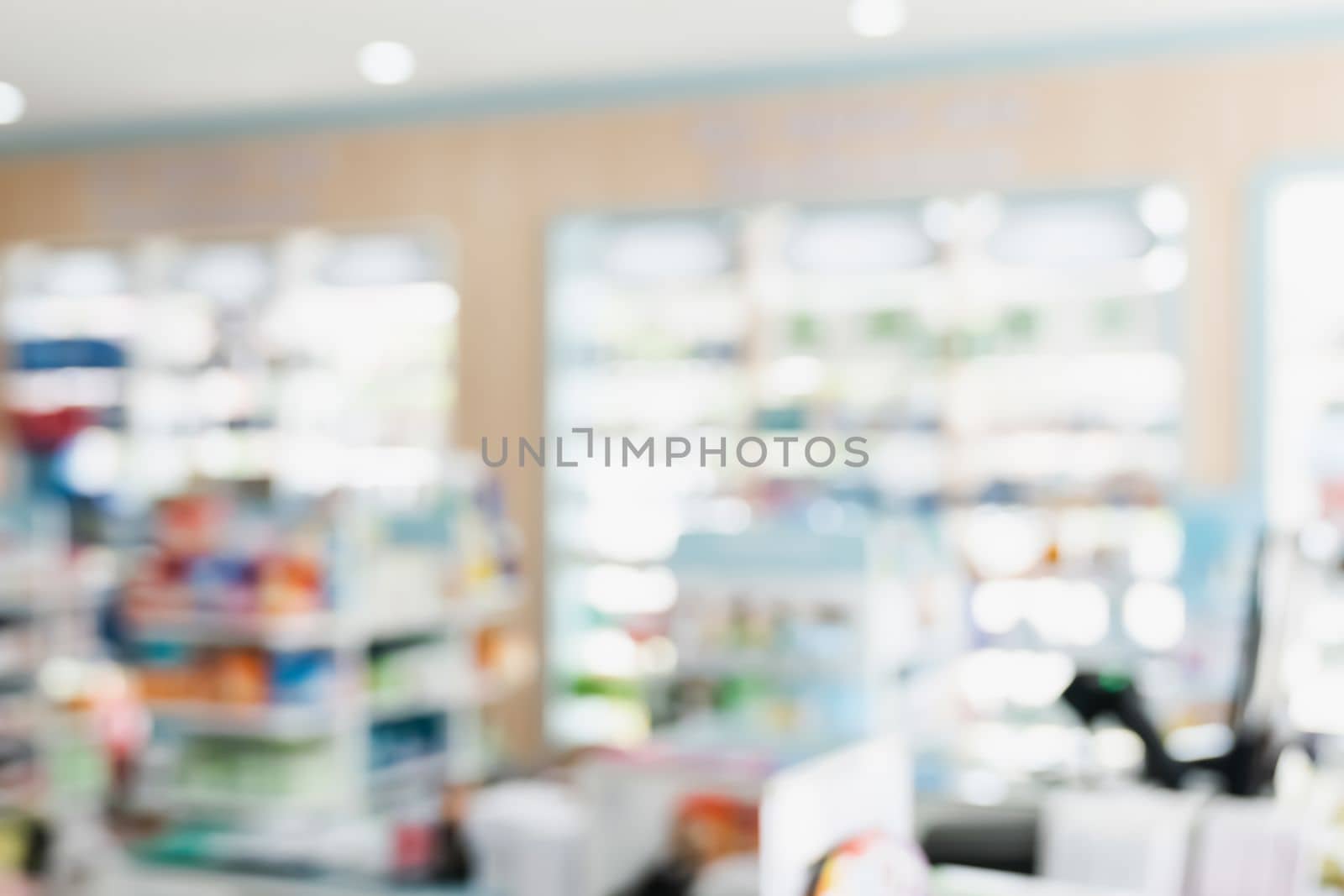 Background of blurred qualified pharmacy abstract background with drugs on shelf by biancoblue