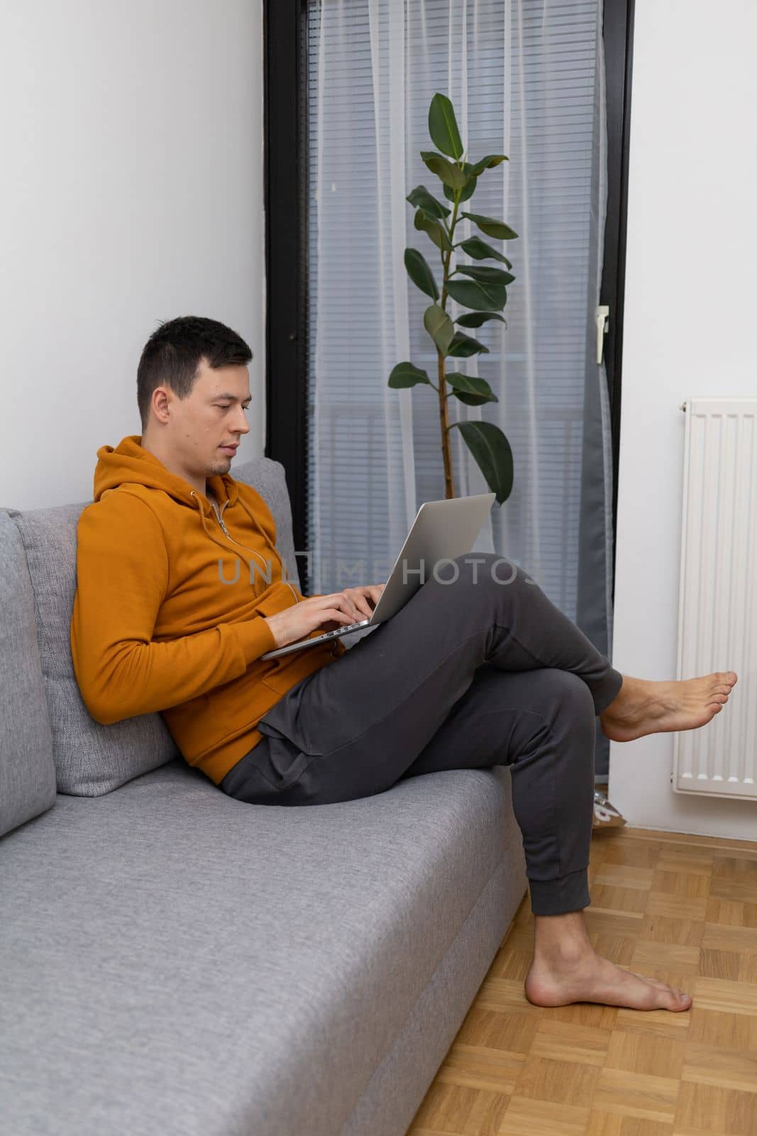 young man watching at laptop playing game. High quality photo