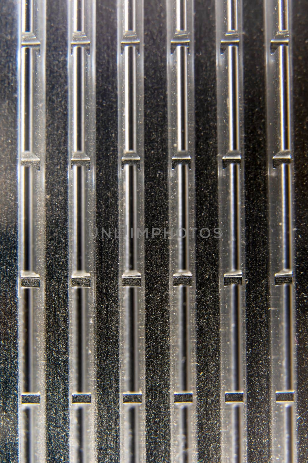 background of aluminum Cooling radiator of the video card processor. External graphics card. The concept of electro and microprocessor technologies. Selective focus. black and white, vertical photo