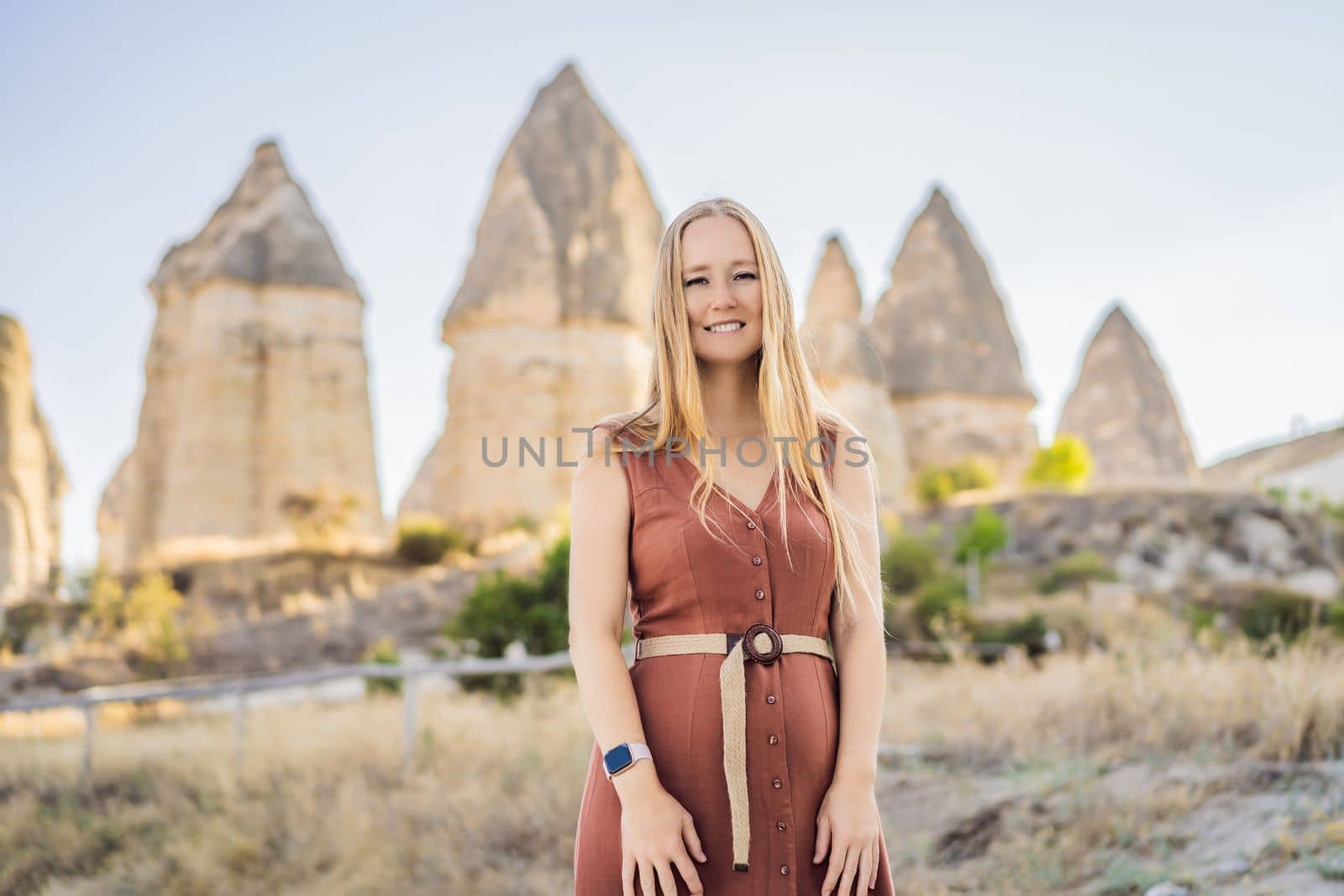 Woman tourist on background of Unique geological formations in Love Valley in Cappadocia, popular travel destination in Turkey.