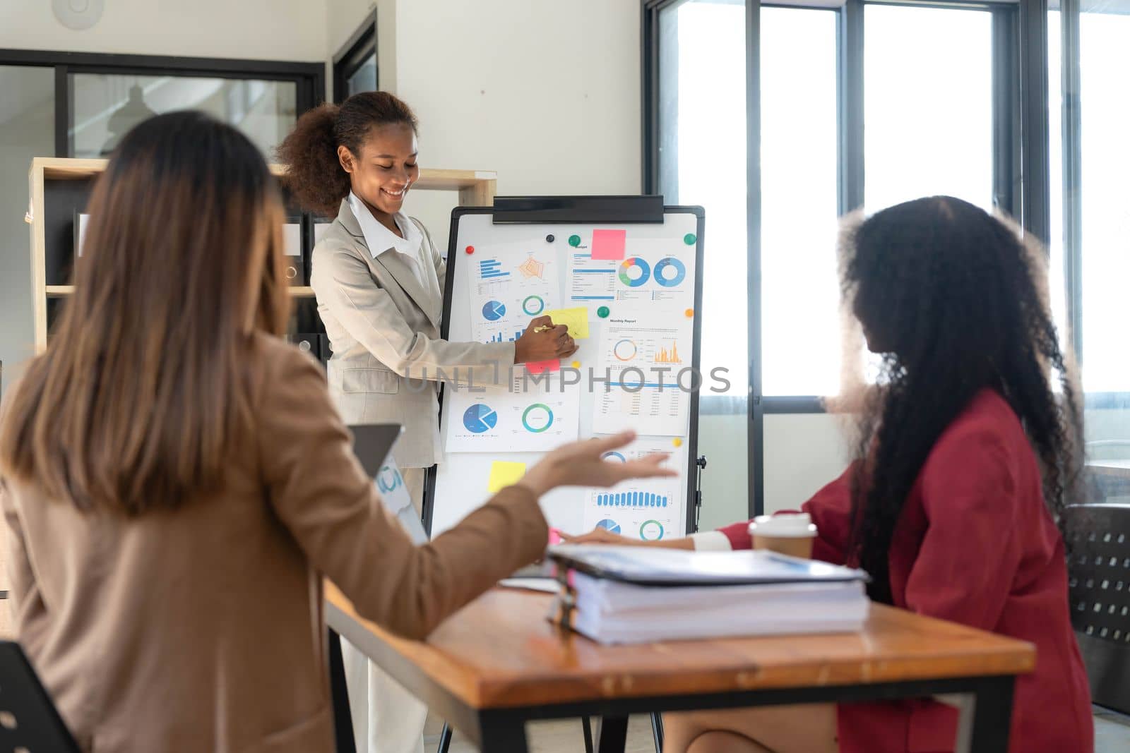 Asian business workgroup designers team with asian woman leader discuss paperwork financial report statistical data, forecasting working on common project. Brainstorm, briefing activity concept..