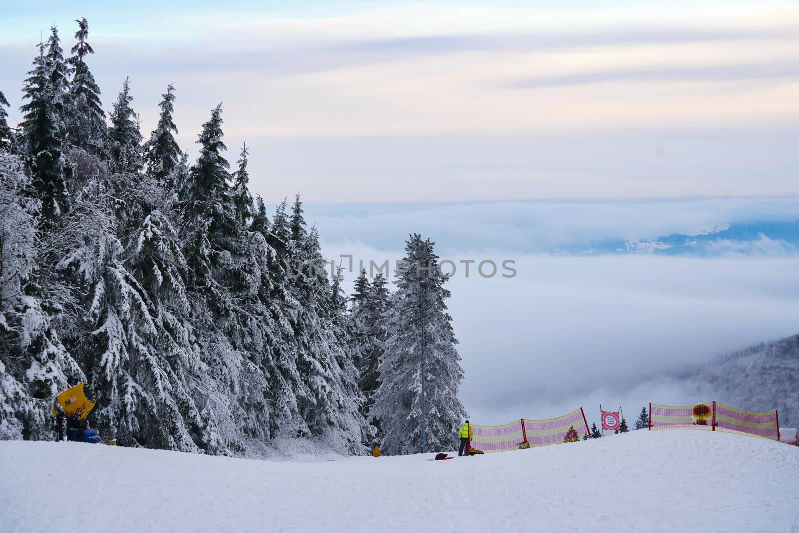 Mountains Winter mountains panorama with ski slopes and ski lifts among spruce forest on a background of mountain ranges and sky in Germany Hessen Rhoen on Wasserkuppe . High quality photo by Costin