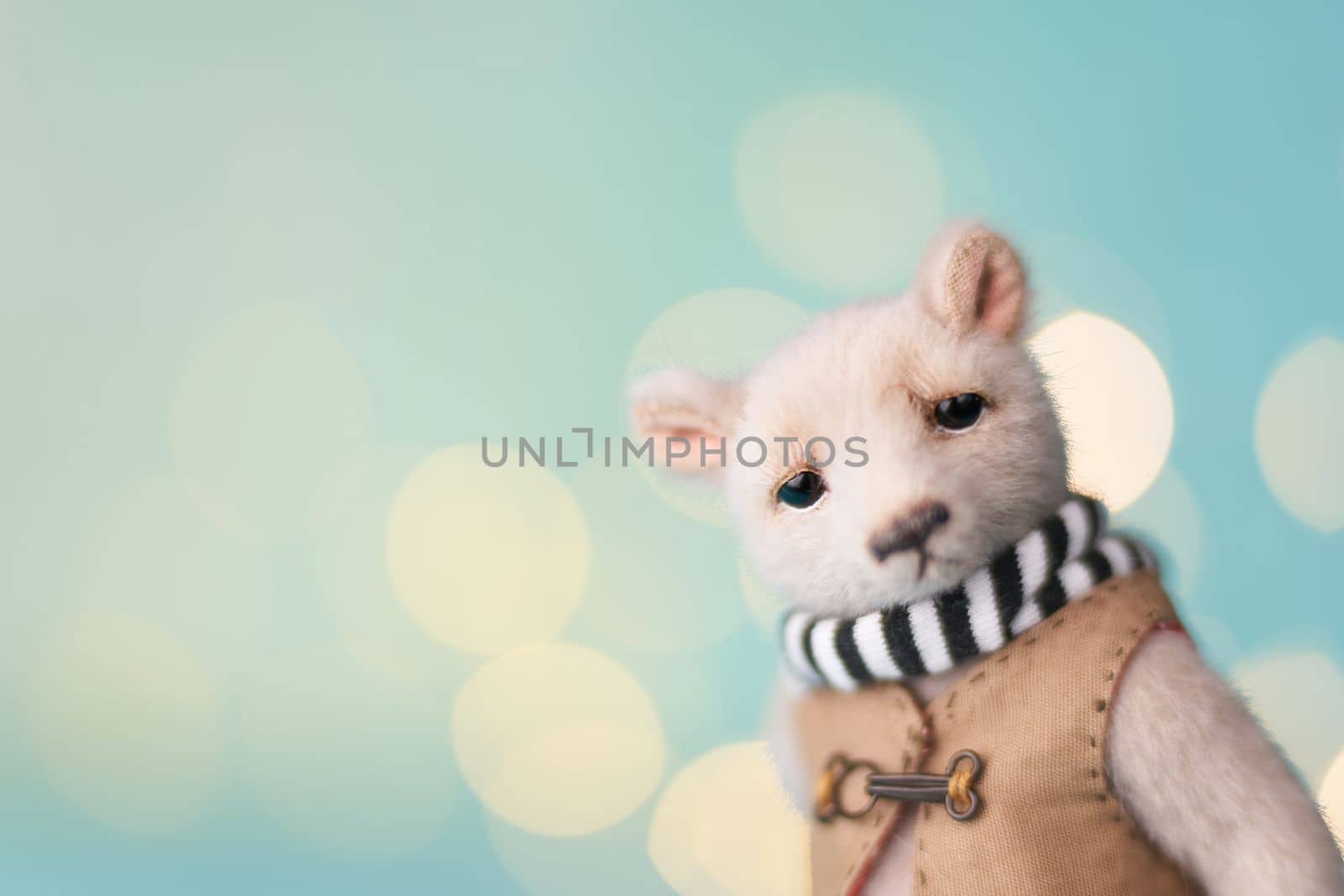 Cute teddy bear isolated on Christmas light background. Holiday glowing backdrop. Defocused Background With Blinking light. Blurred Bokeh. by Costin