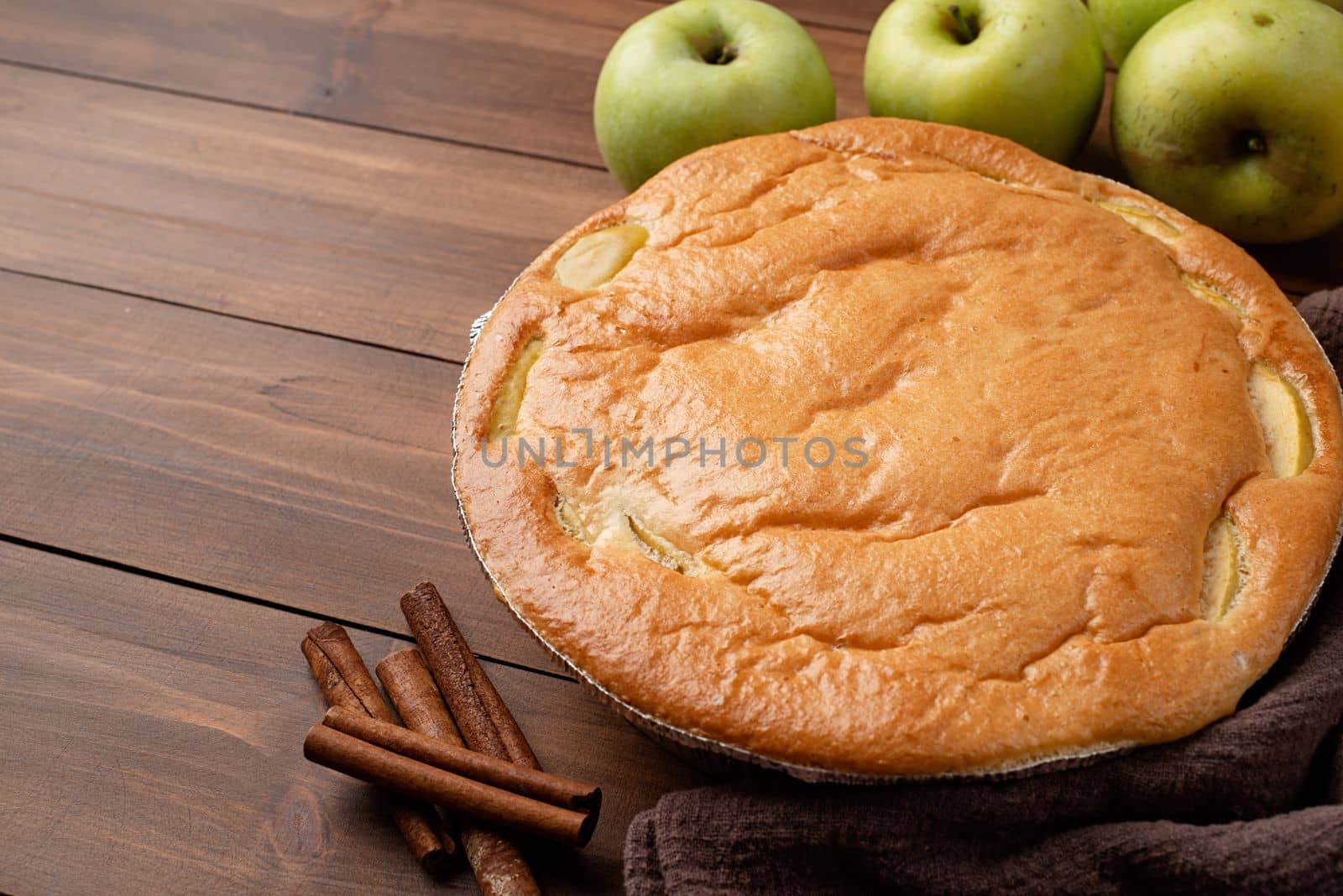 Traditional charlotte apple pie charlotte on wooden table with fresh apple and cinnamon