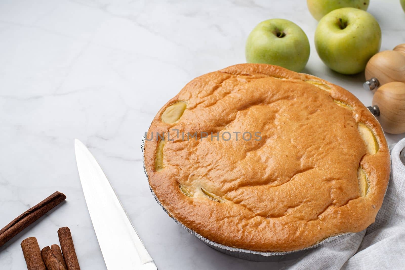 Traditional charlotte apple pie charlotte on concrete table with fresh apple and cinnamon