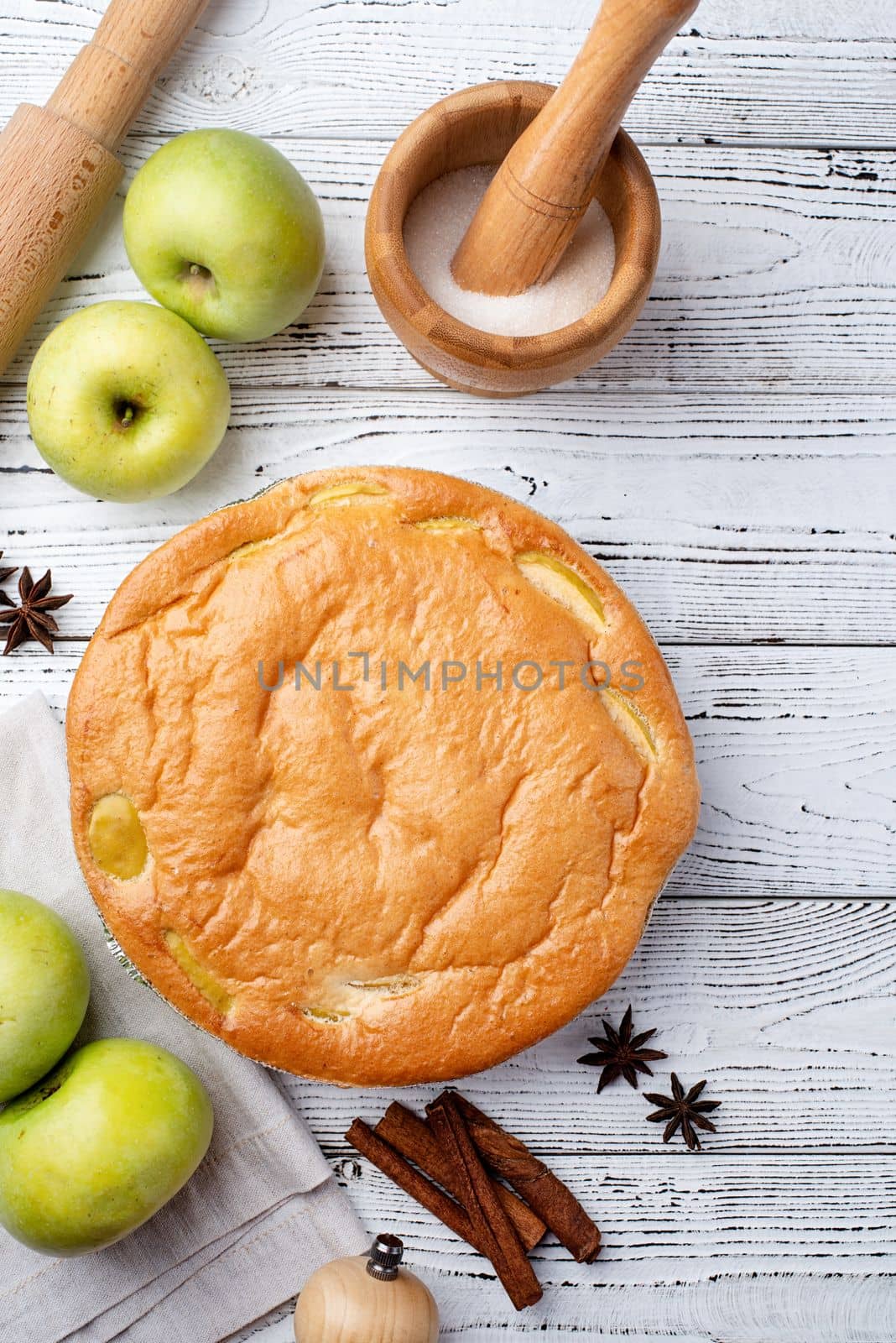 Traditional charlotte apple pie charlotte on white wooden table with fresh apple and cinnamon , view from above