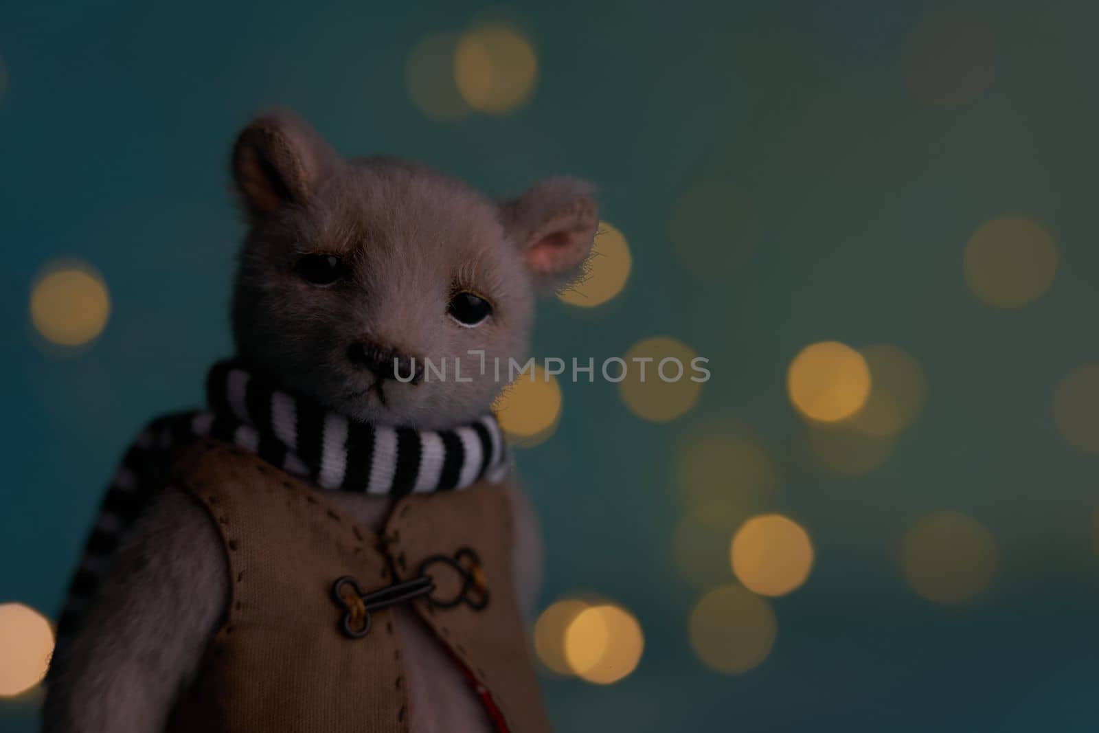 Cute teddy bear isolated on Christmas light background. Holiday glowing backdrop. Defocused Background With Blinking light. Blurred Bokeh. by Costin