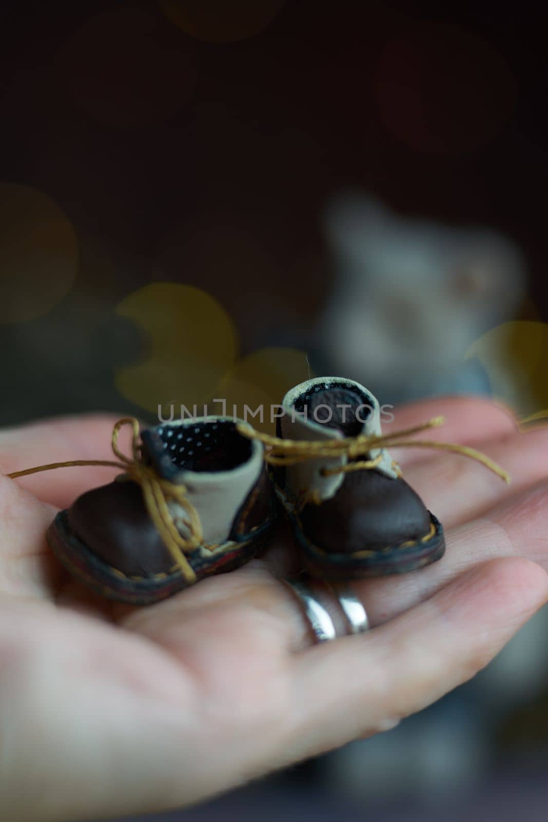 leather small shoes for teddy bear or doll on the hand. the concept of light industry for the manufacture of stylish fashionable shoes for children with small feet and their parents. High quality photo