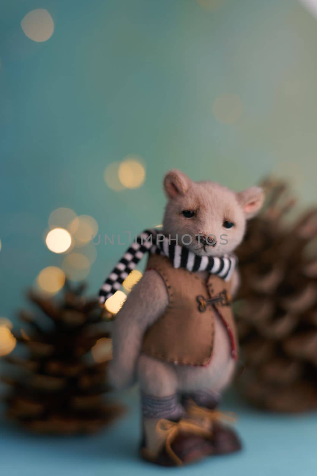 Cute teddy bear isolated on Christmas light background. Holiday glowing backdrop. Defocused Background With Blinking light. Blurred Bokeh. High quality photo