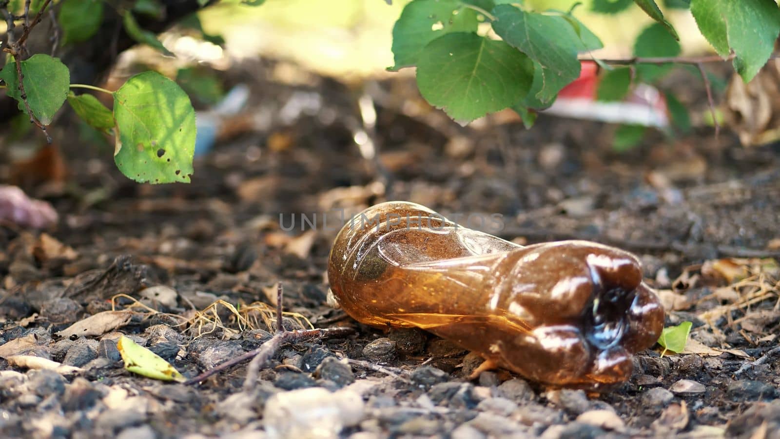 close-up, on the ground lying old used plastic bottle. garbage, trash, rubbish on street, outdoors. ecology, pollution of the environment. High quality photo