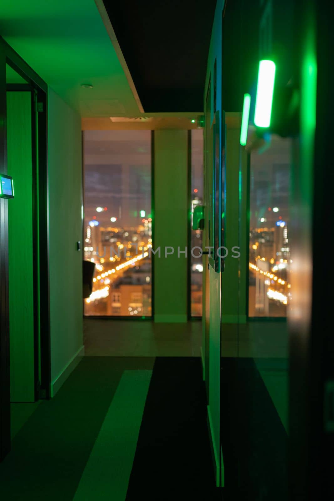 Futuristic office with city night lights reflection in the background.