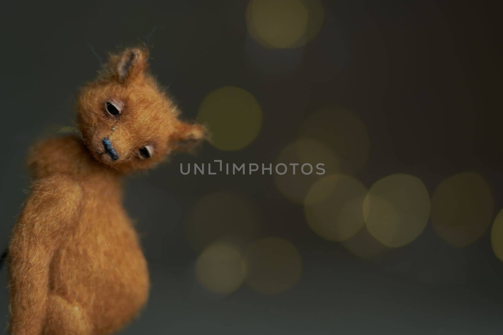 Cute teddy bear isolated on light background. Holiday glowing backdrop. Defocused background with blinking light. Blurred Bokeh. copy space. by Costin