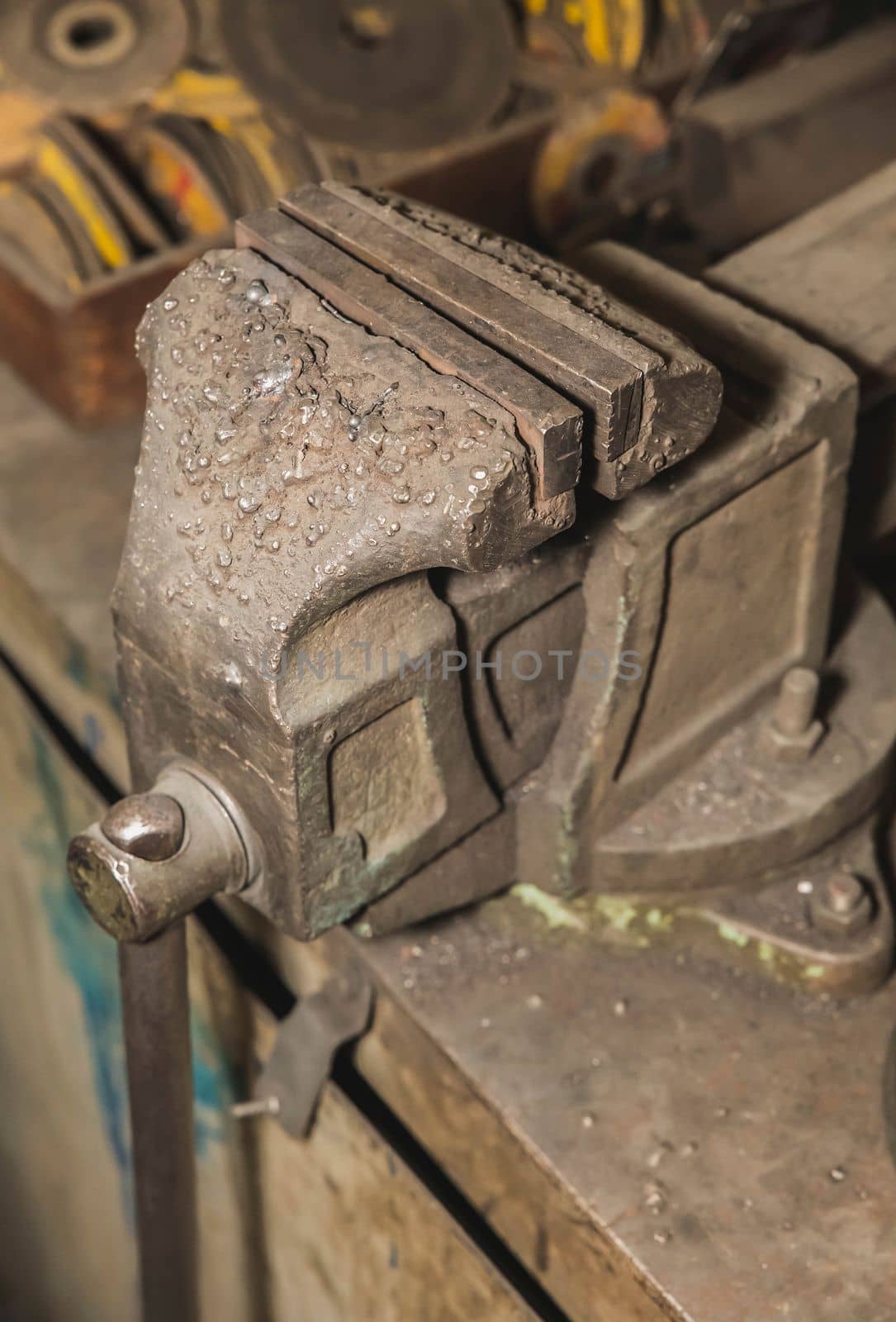 Old vise with drips of molten metal.