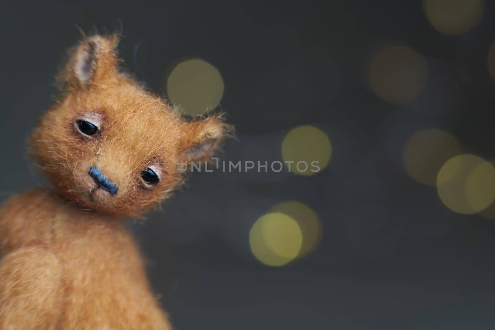 Cute teddy bear isolated on light background. Holiday glowing backdrop. Defocused background with blinking light. Blurred Bokeh. copy space. by Costin