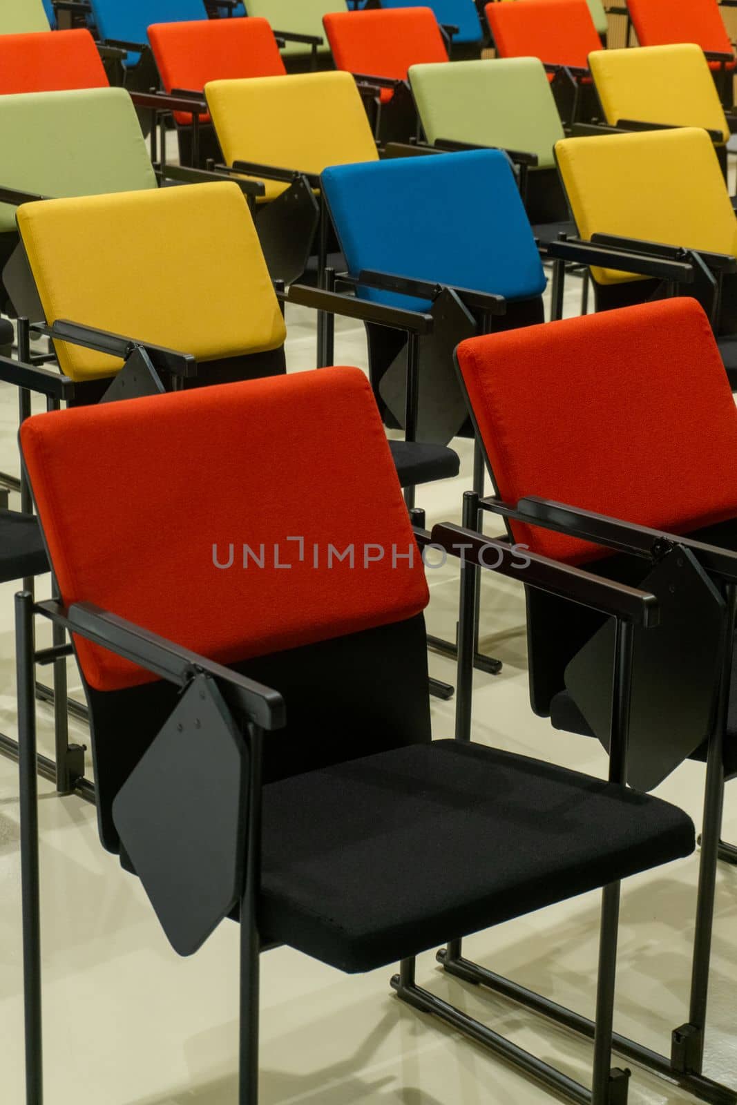Rows of colourful seats in the hall background