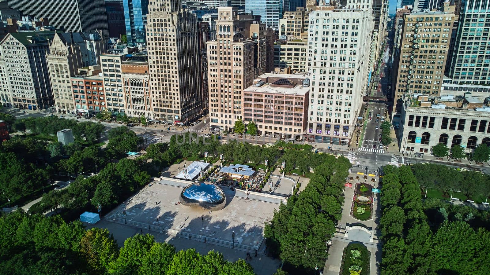 Chicago Millennium Park aerial view of iconic Cloud Gate Bean by skyscrapers by njproductions