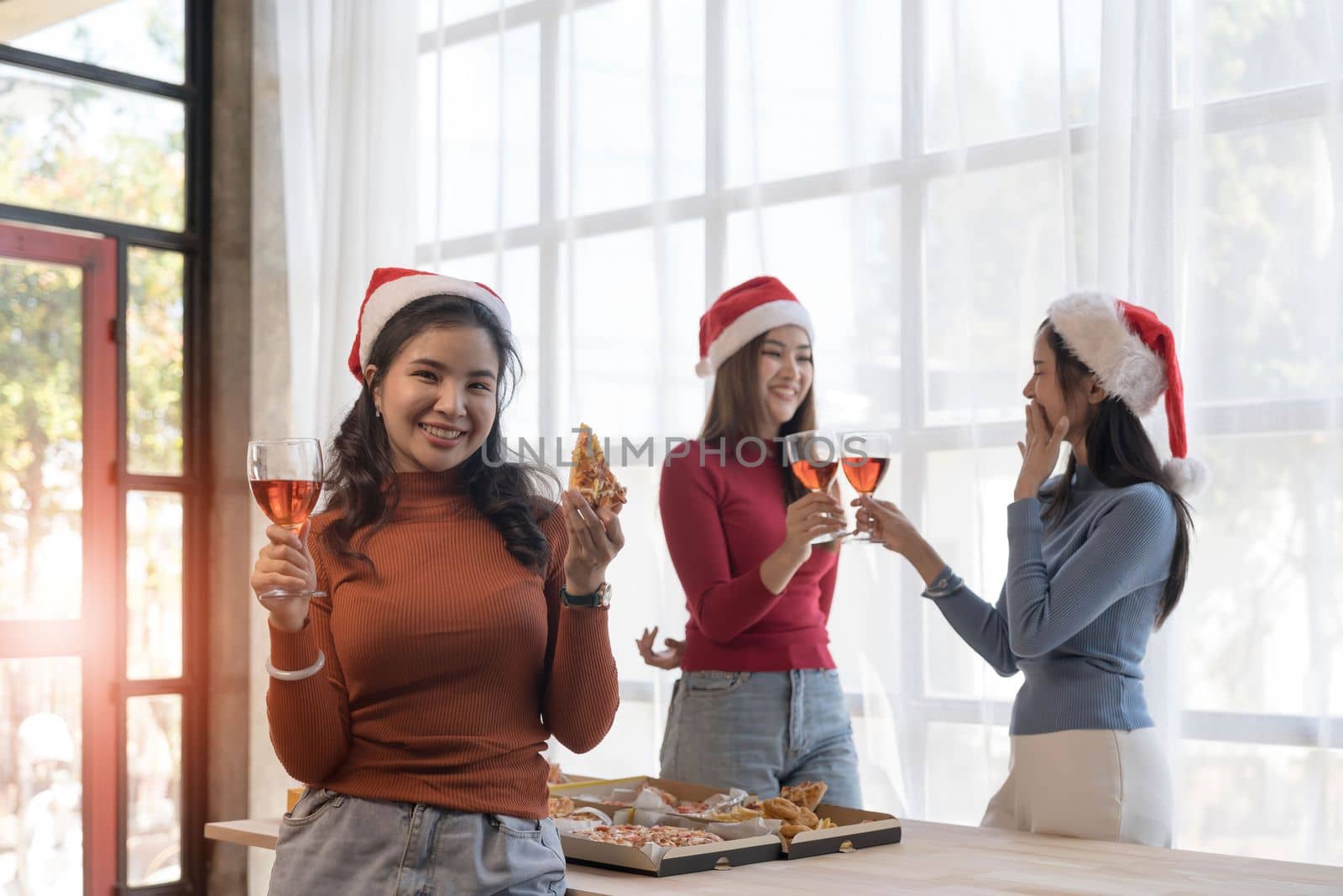 Group of young asian office girl friends having fun, talking and eating pizza together with happiness and fun. Lifestyle Concept.