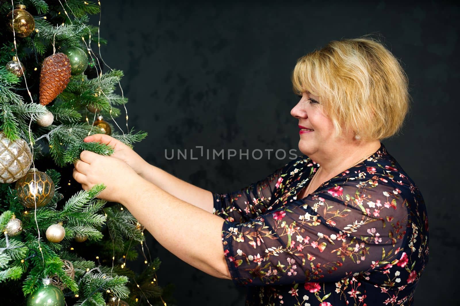 Overweight decorating beautiful Christmas tree with ornamets at home, closeup. christmas holidays and people concept. Christmas atmosphere
