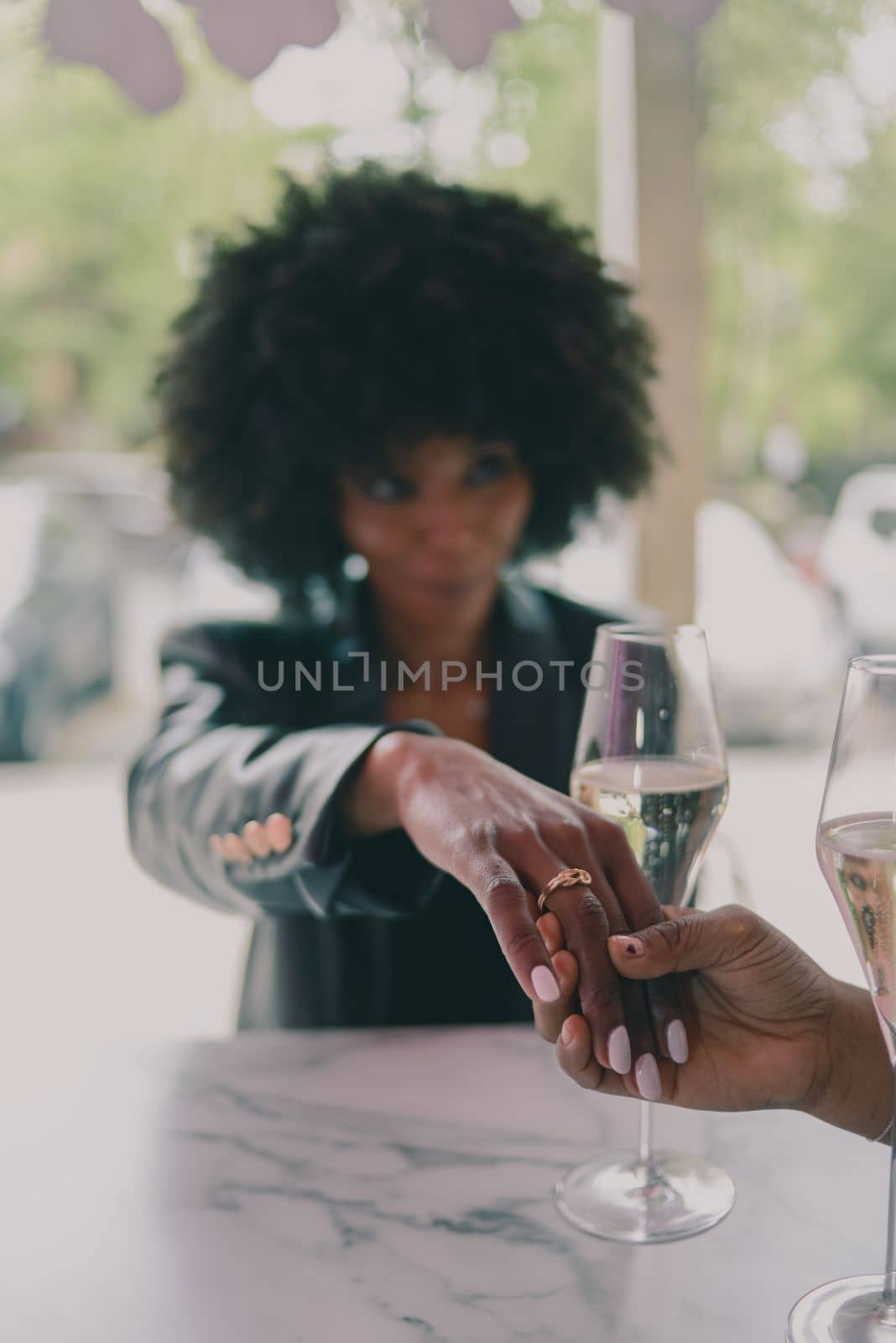 LGBT. Lesbian couple together concept. Couple of young asian woman and african woman drinking and having fun in a bar.