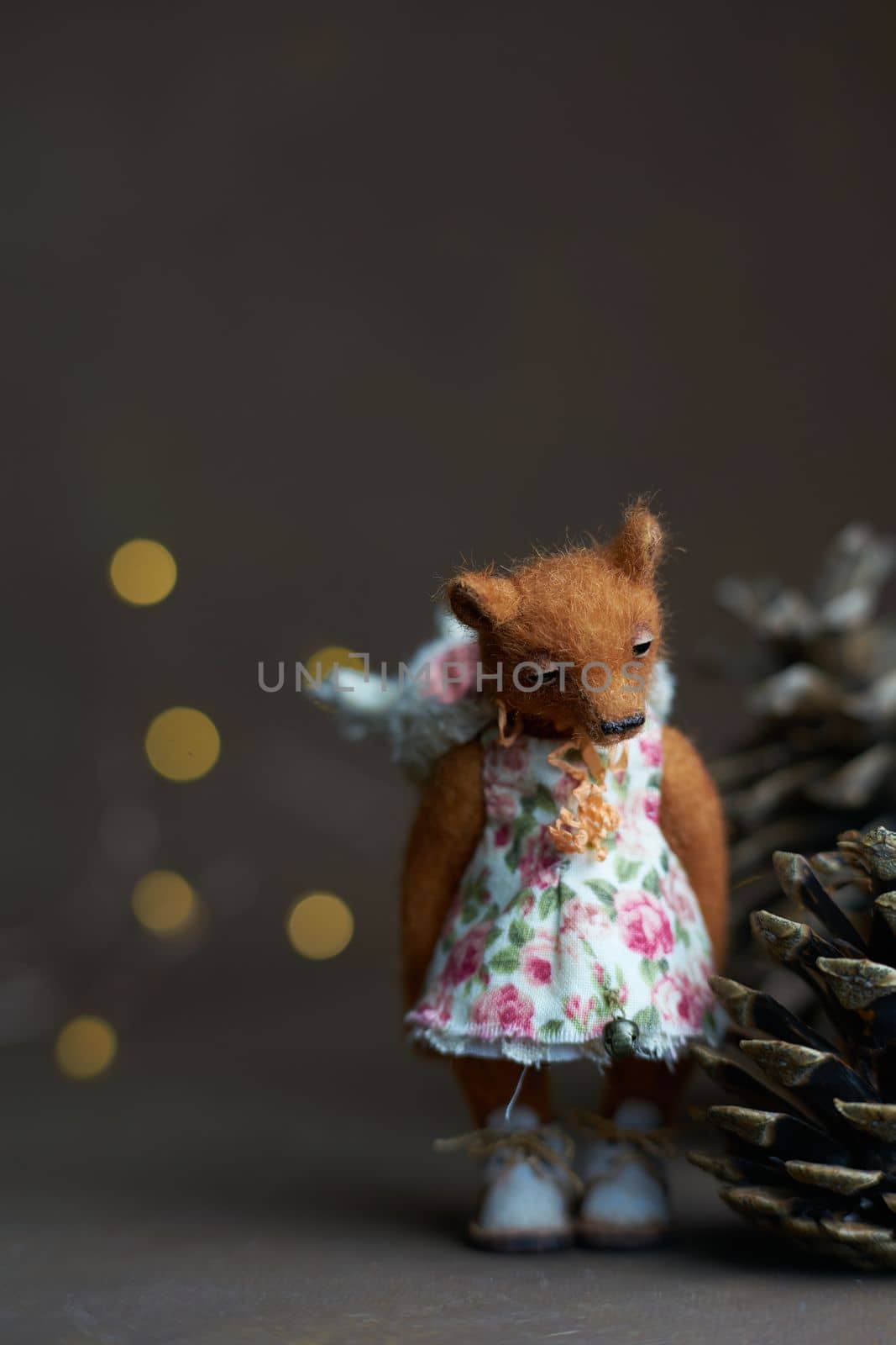 Cute teddy bear isolated on light background. Holiday glowing backdrop. Defocused background with blinking light. Blurred Bokeh. copy space. High quality photo