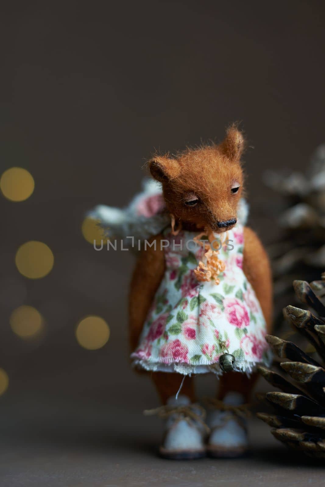 Cute teddy bear isolated on light background. Holiday glowing backdrop. Defocused background with blinking light. Blurred Bokeh. copy space. High quality photo